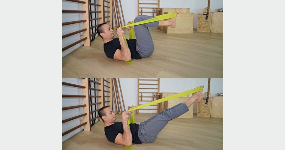 Michel demonstrating leg and footwork prehensile with the elastic band